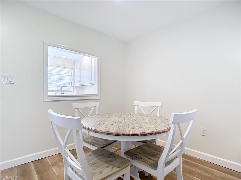 180 Turtle Lake Court, Unit 206 Naples, FL 34105 - Photo 19 of 50 a view of a dining room with furniture and a window