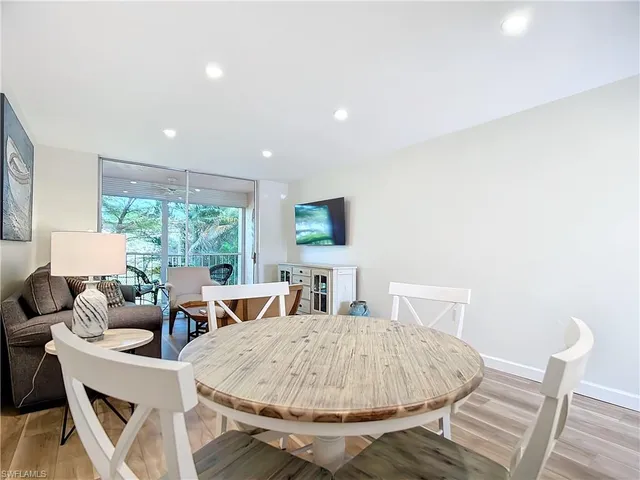 a living room with furniture a window and a flat screen tv