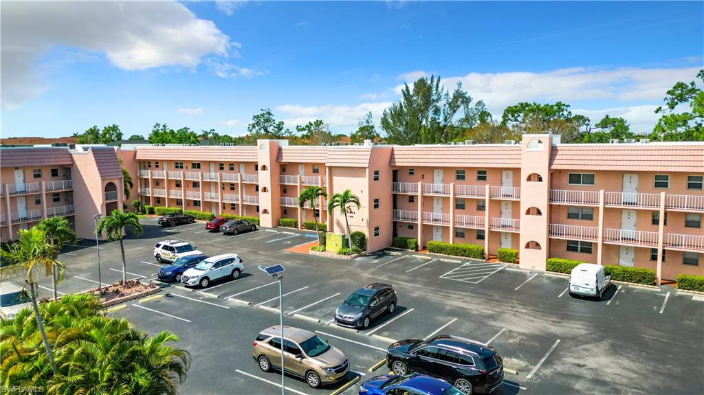 180 Turtle Lake Court, Unit 206 Naples, FL 34105 - Photo 2 of 50 a car parked in front of a building