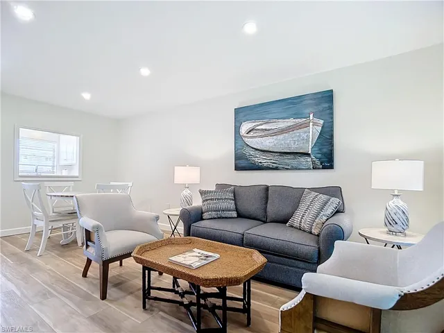 a living room with furniture a rug and a window