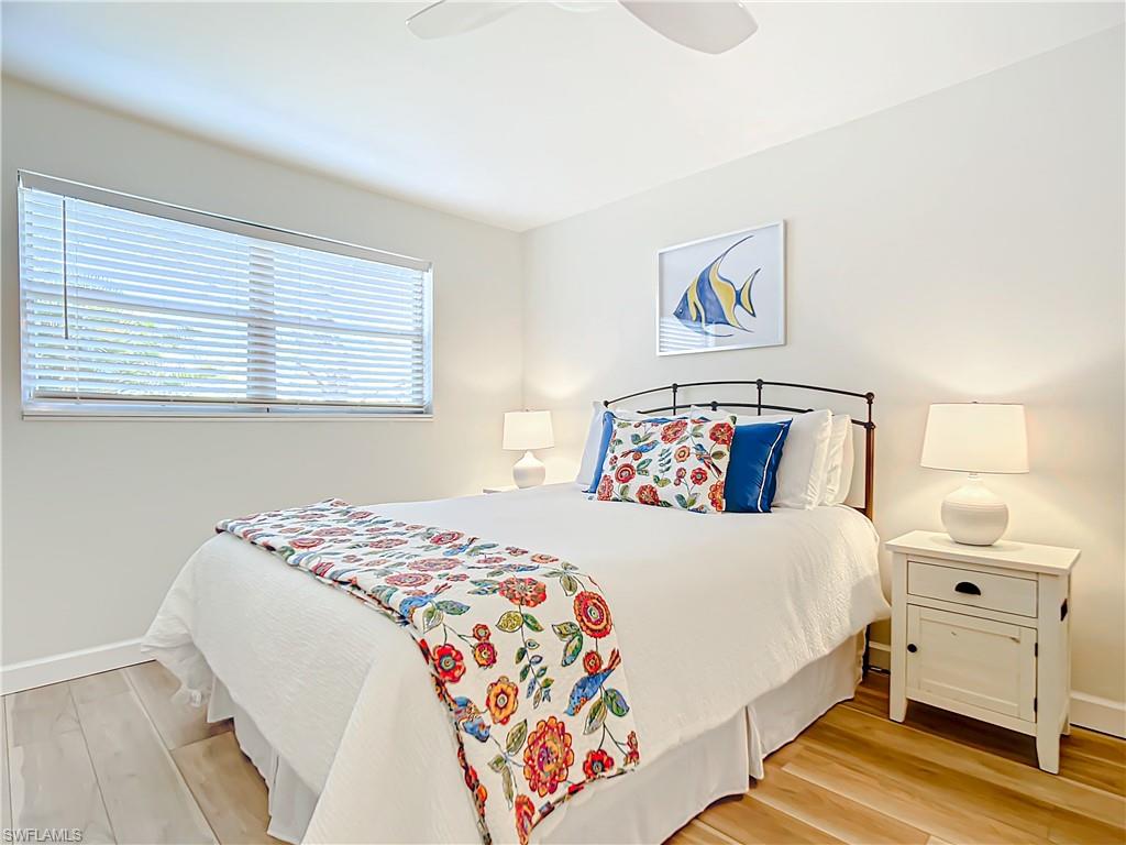 180 Turtle Lake Court, Unit 206 Naples, FL 34105 - Photo 30 of 50 a bedroom with a bed and a painting on the wall