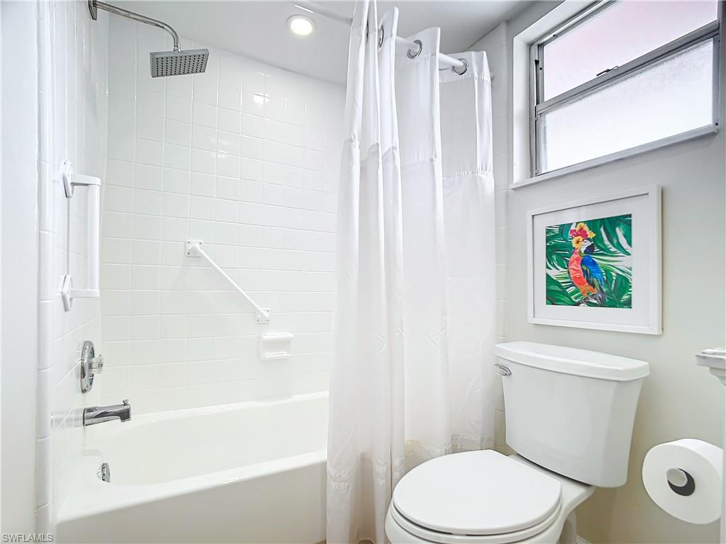 180 Turtle Lake Court, Unit 206 Naples, FL 34105 - Photo 37 of 50 a white toilet sitting next to a bath tub shower