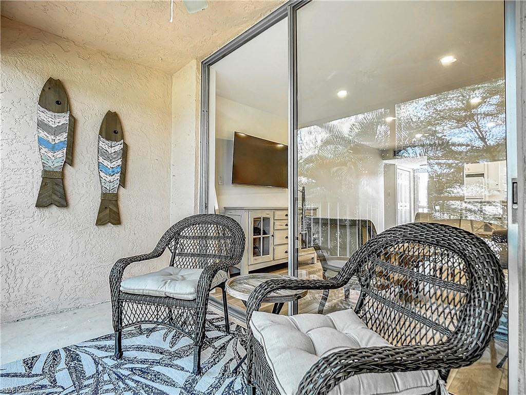 180 Turtle Lake Court, Unit 206 Naples, FL 34105 - Photo 39 of 50 a living room with furniture
