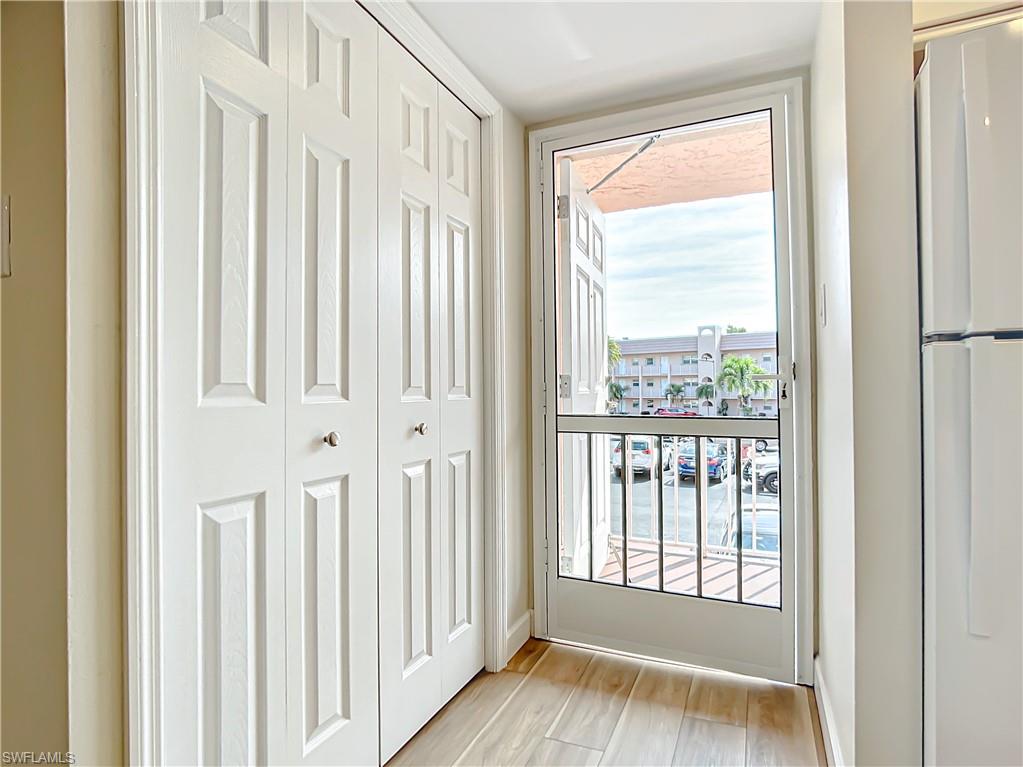 180 Turtle Lake Court, Unit 206 Naples, FL 34105 - Photo 4 of 50 a view of front door with a wooden floor