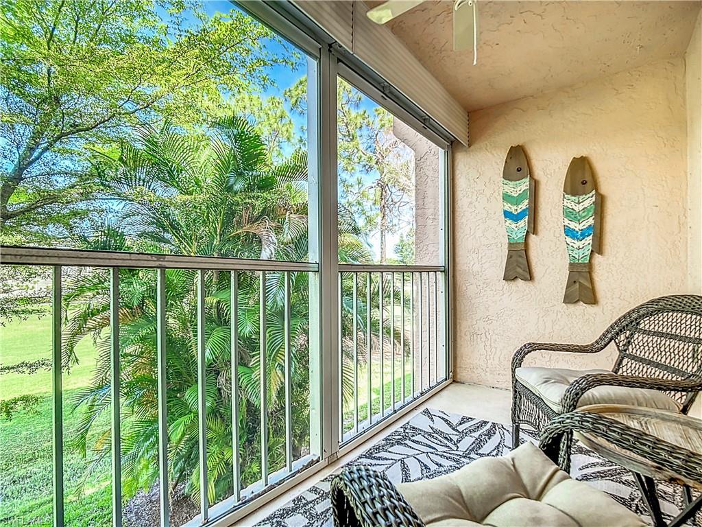 180 Turtle Lake Court, Unit 206 Naples, FL 34105 - Photo 41 of 50 a balcony with furniture and garden view
