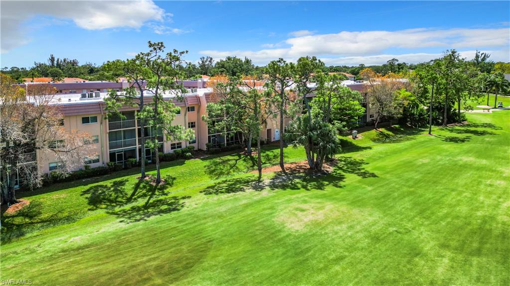 180 Turtle Lake Court, Unit 206 Naples, FL 34105 - Photo 44 of 50 a view of a garden with a houses
