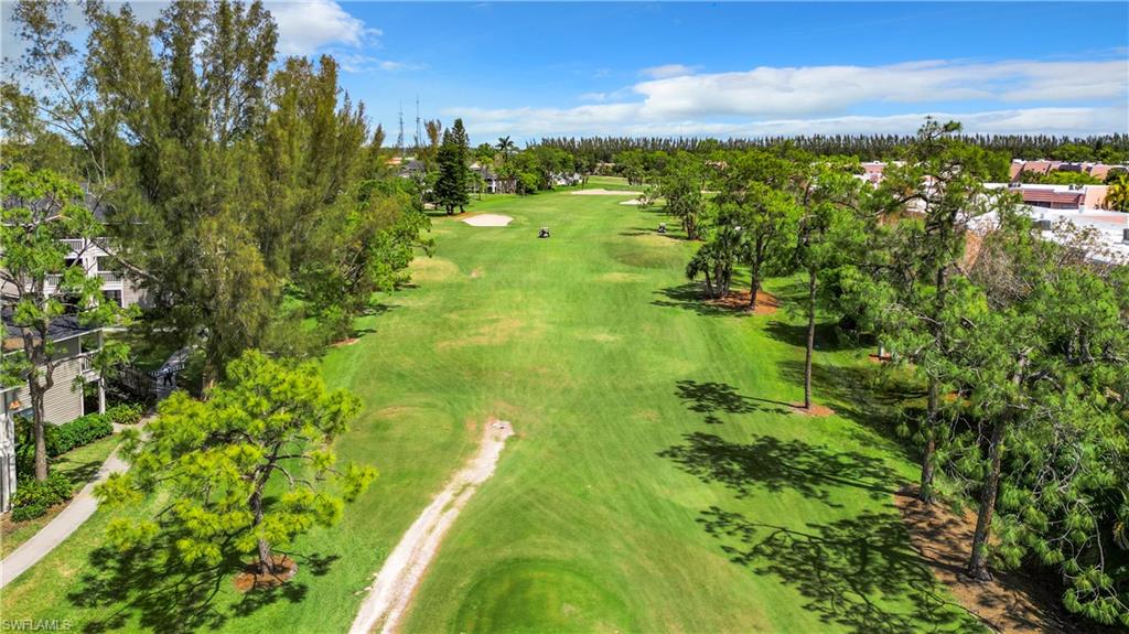 180 Turtle Lake Court, Unit 206 Naples, FL 34105 - Photo 45 of 50 a view of a lake with a building in the background