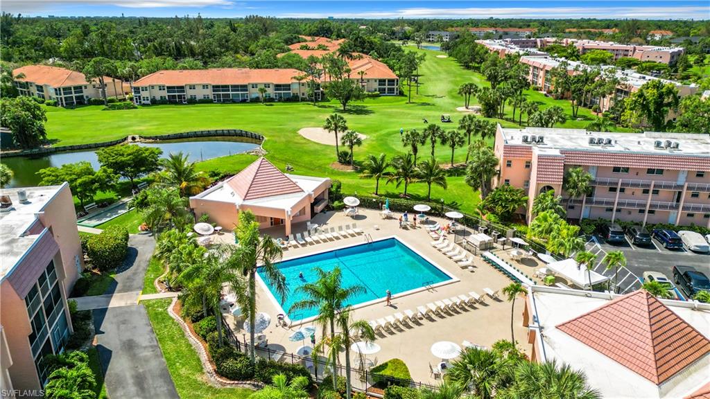 180 Turtle Lake Court, Unit 206 Naples, FL 34105 - Photo 46 of 50 an aerial view of a house with a garden and swimming pool