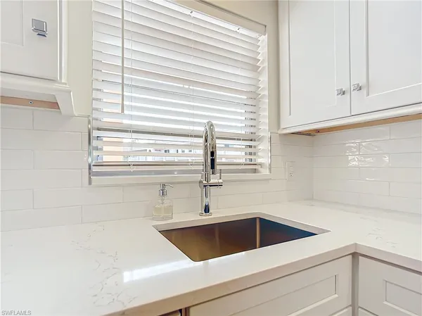 a view white cabinets and a sink