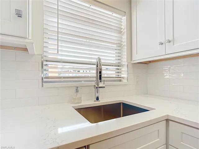 a view white cabinets and a sink