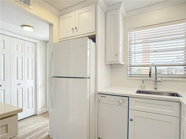 a white refrigerator freezer sitting inside of a kitchen
