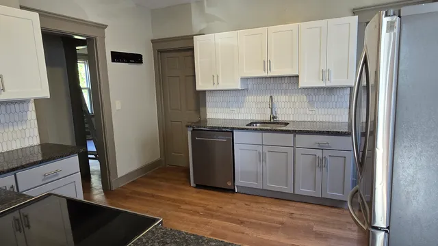 a kitchen with stainless steel appliances granite countertop a refrigerator sink and cabinets