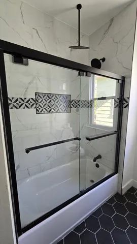 a bathroom with a bathtub and a shower