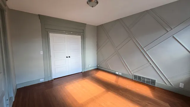 a view of a room with wooden floor