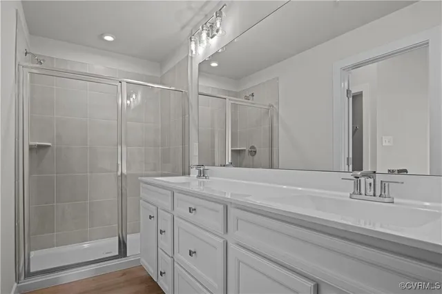 a bathroom with a granite countertop toilet sink and mirror