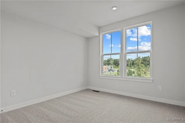 a view of an empty room and closet area