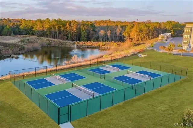 an aerial view of a golf course with a swimming pool