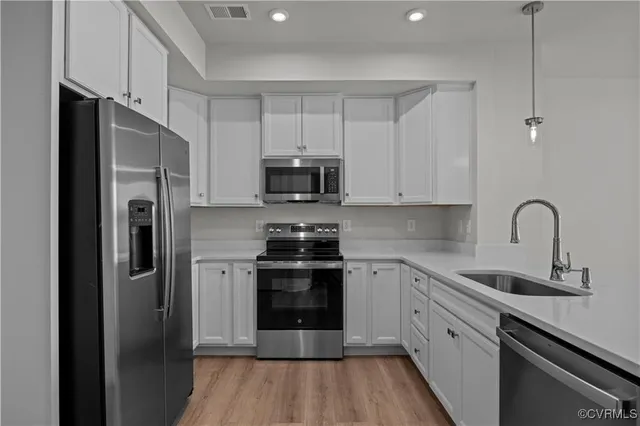a bathroom with a double vanity sink a mirror and a bathtub