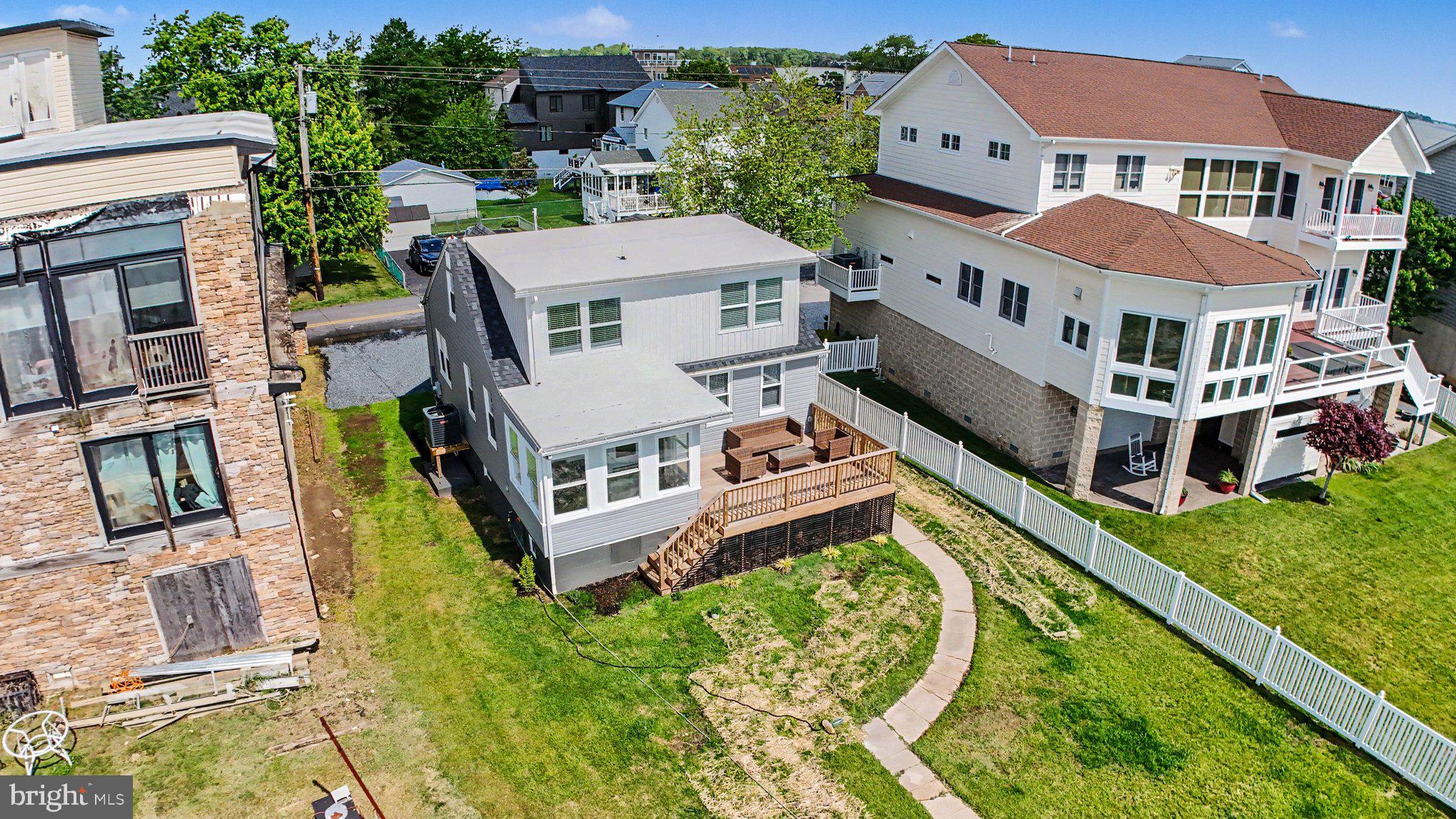 9135 Cuckold Point Road Sparrows Point, MD 21219 - Photo 5 of 44 an aerial view of a house with a big yard and potted plants