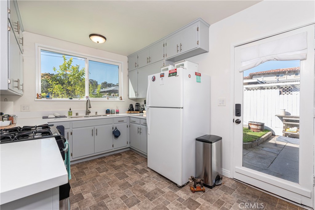 210 Vía Alameda Redondo Beach, CA 90277 - Photo 6 of 19 a kitchen with a refrigerator a stove a washer dryer and a dining table