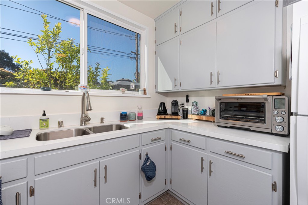 210 Vía Alameda Redondo Beach, CA 90277 - Photo 8 of 19 a kitchen with stainless steel appliances white cabinets and a stove top oven