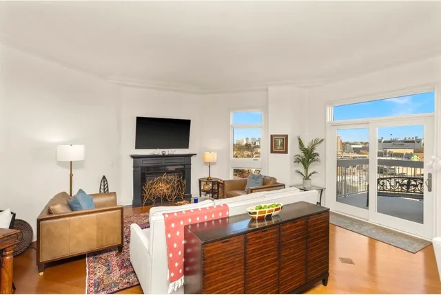 a kitchen with stainless steel appliances granite countertop a stove top oven a sink a refrigerator with white cabinets and granite countertops