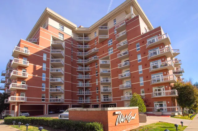 a kitchen with granite countertop a sink a stove and cabinets