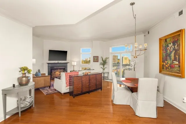 a kitchen with stainless steel appliances granite countertop a stove a refrigerator a sink a stove a dining table and chairs