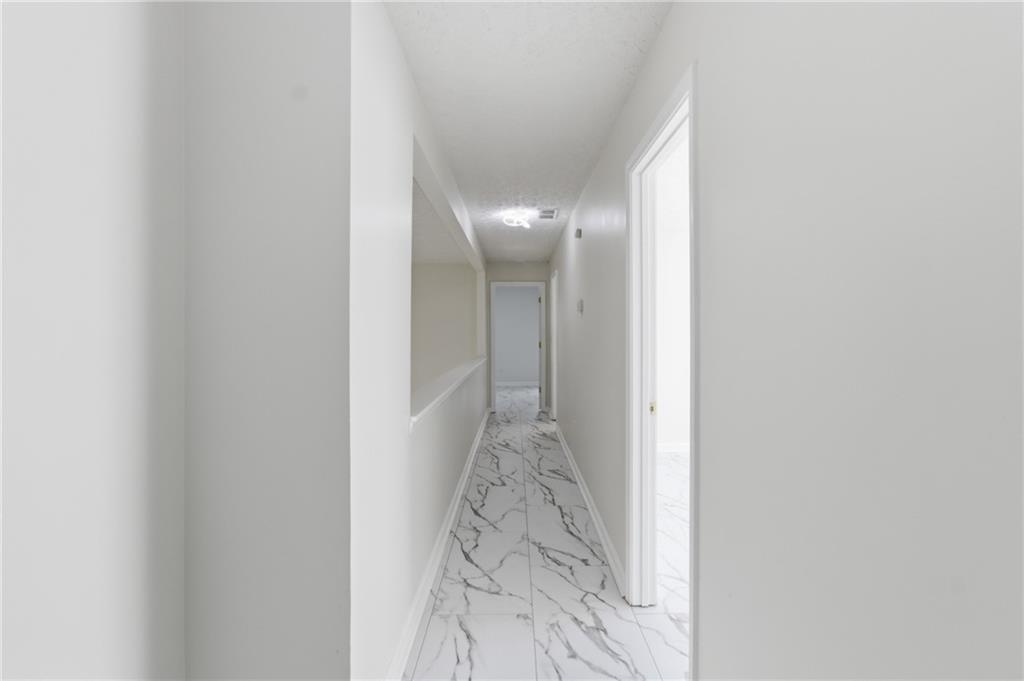 3760 Mountain Cove Road Snellville, GA 30039 - Photo 22 of 73 a view of a hallway with wooden floor
