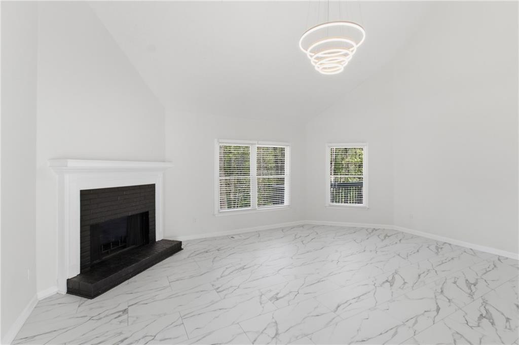 3760 Mountain Cove Road Snellville, GA 30039 - Photo 36 of 73 a view of an empty room with a fireplace and a window