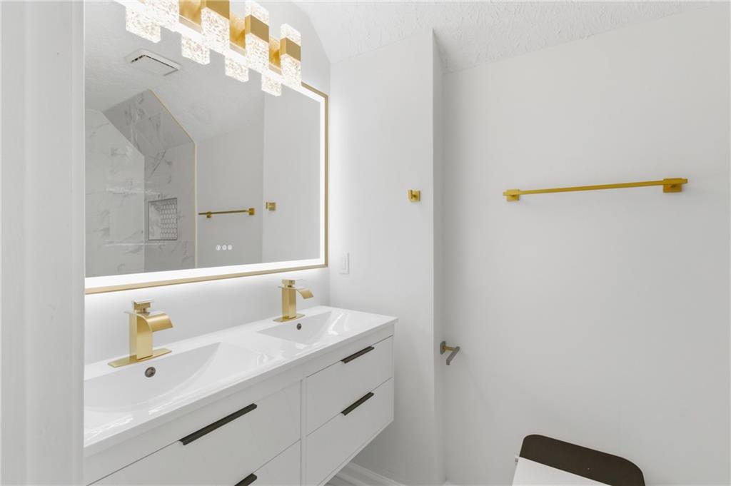 3760 Mountain Cove Road Snellville, GA 30039 - Photo 44 of 73 a bathroom with a sink a vanity and a mirror