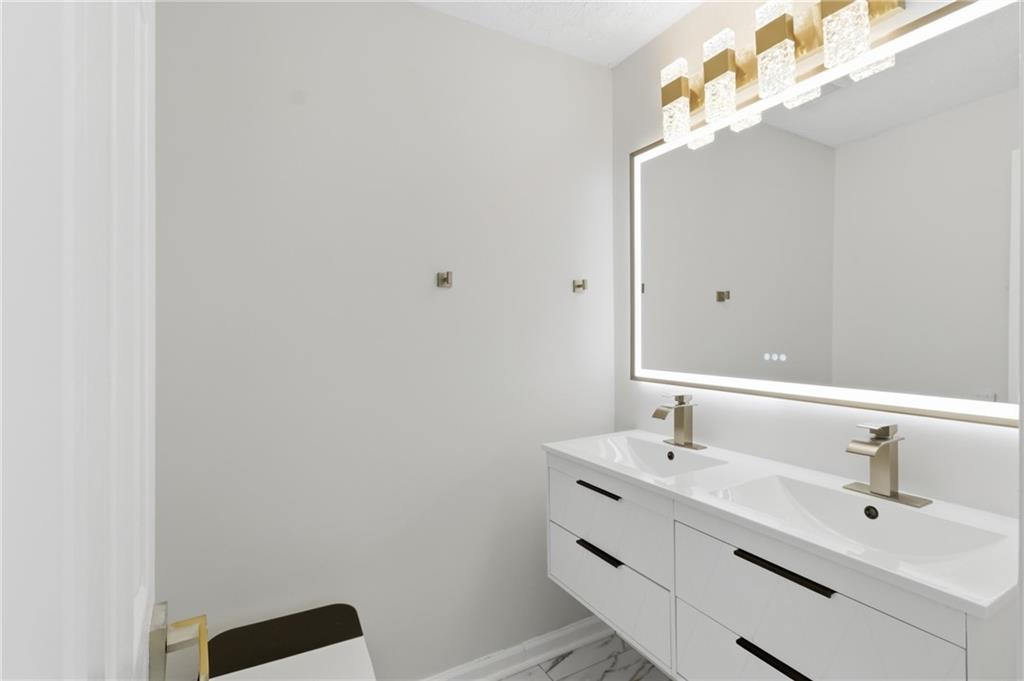 3760 Mountain Cove Road Snellville, GA 30039 - Photo 47 of 73 a bathroom with a sink mirror and vanity