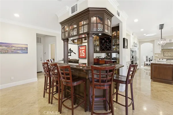a view of a dining room with furniture and chandelier