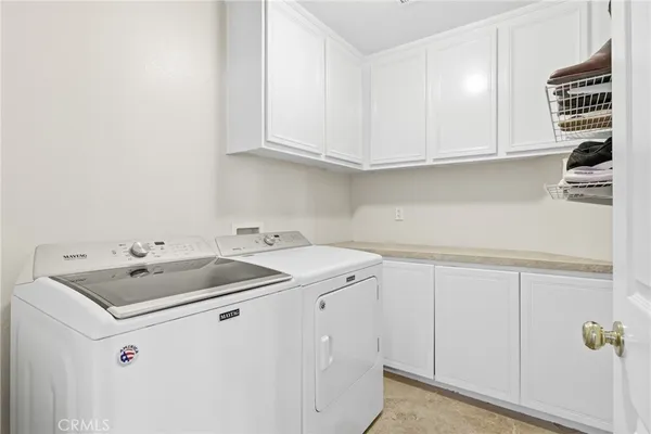 a utility room with sink dryer and washer