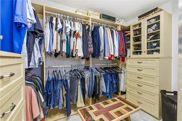 a view of walk in closet with clothes