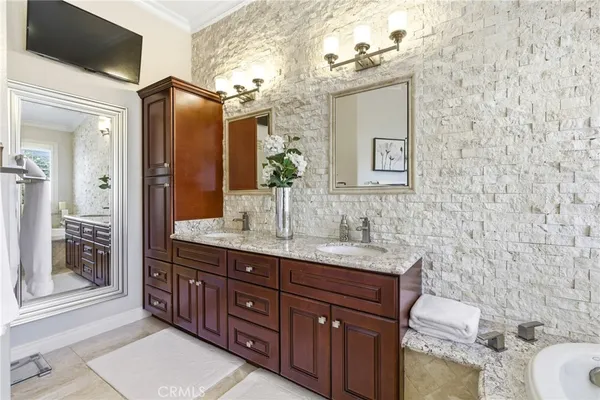 a bathroom with a granite countertop sink toilet and mirror