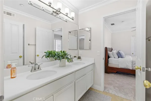 a bathroom with a sink double vanity and a mirror