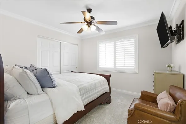 a bedroom with a bed a couch and a window