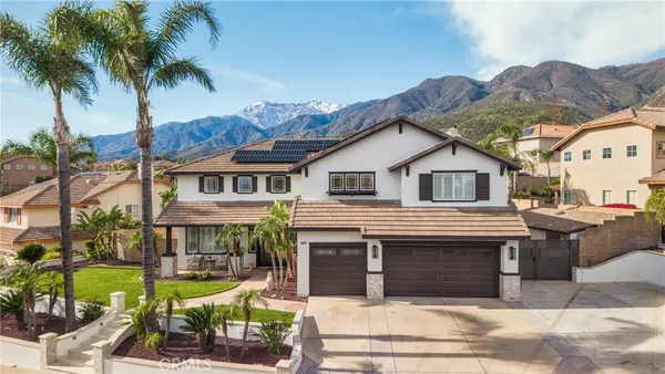an aerial view of a house with a yard and garden