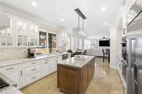 a large kitchen with kitchen island a large counter top space appliances and a center island