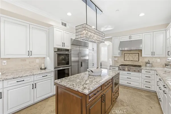 a kitchen with stainless steel appliances granite countertop a stove oven and a refrigerator