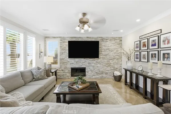 a living room with fireplace furniture a flat screen tv and a fireplace