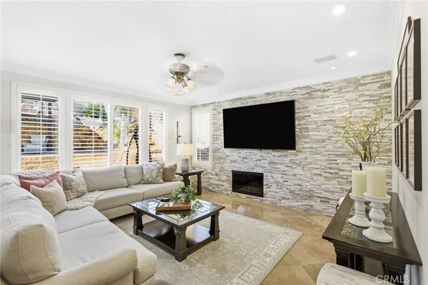 a living room with furniture fireplace and a flat screen tv