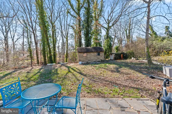 a backyard of a house with barbeque oven table and chairs
