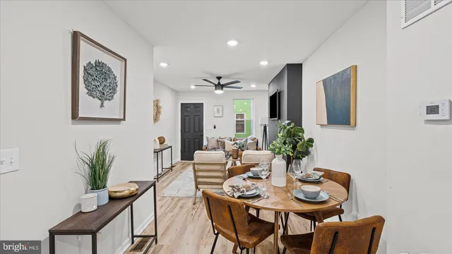 a view of a dining room with furniture and wooden floor