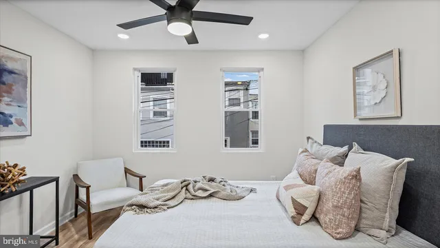a bedroom with furniture and a large window