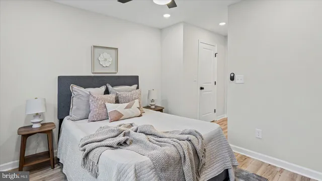 a bedroom with a bed and a painting on the wall