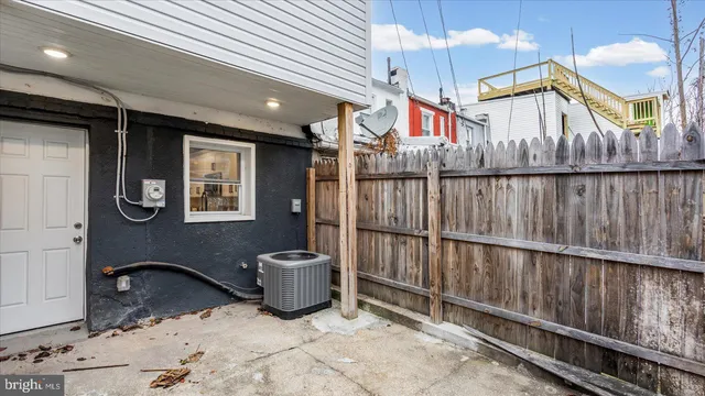 a view of a house with wooden fence