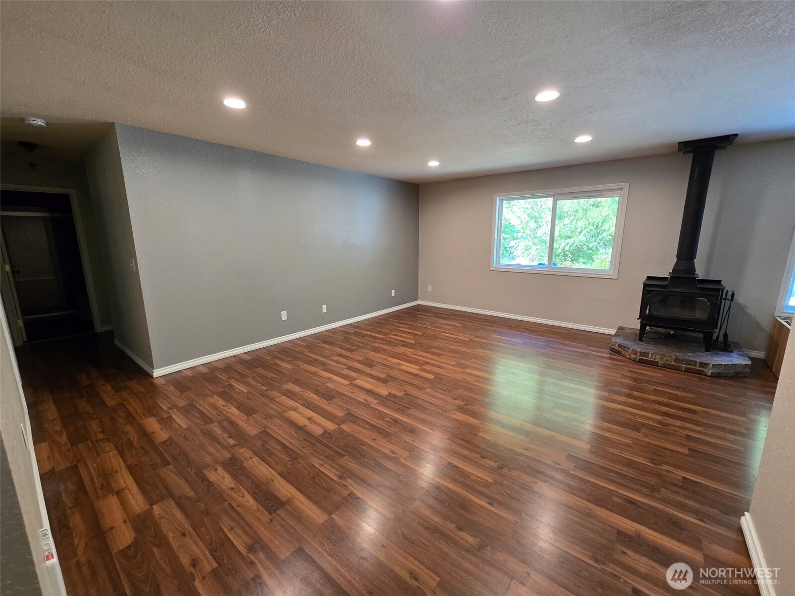 660 Peter Hagen Road West Seabeck, WA 98380 - Photo 11 of 39 an empty room with wooden floor and windows