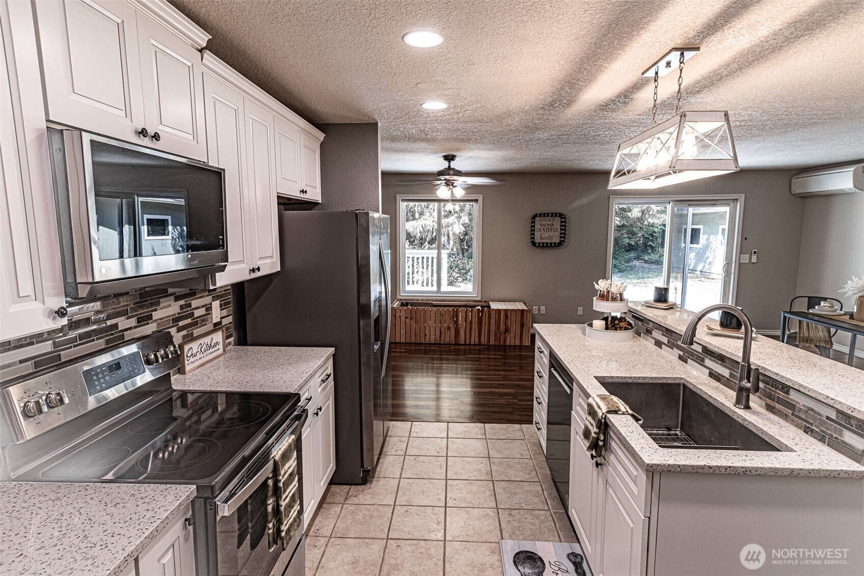 660 Peter Hagen Road West Seabeck, WA 98380 - Photo 15 of 39 a kitchen that has a sink a stove and lots of wooden cabinets